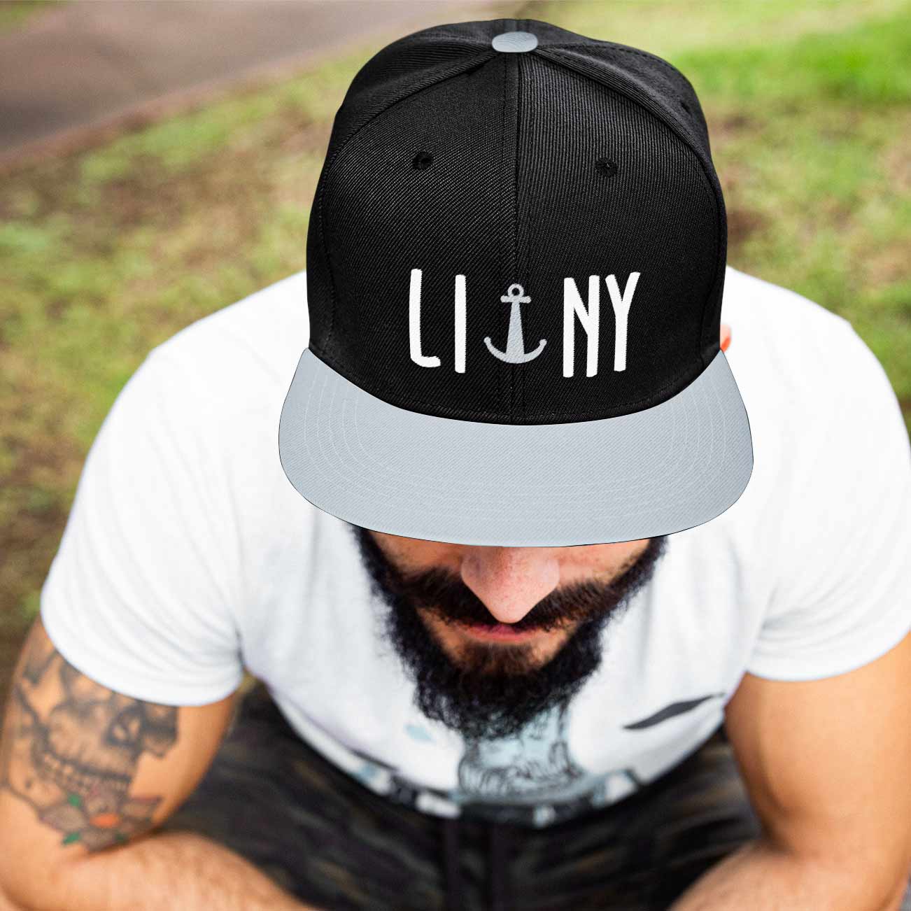 Bearded man wearing black LINY anchor Long Island New York snapback hat cap