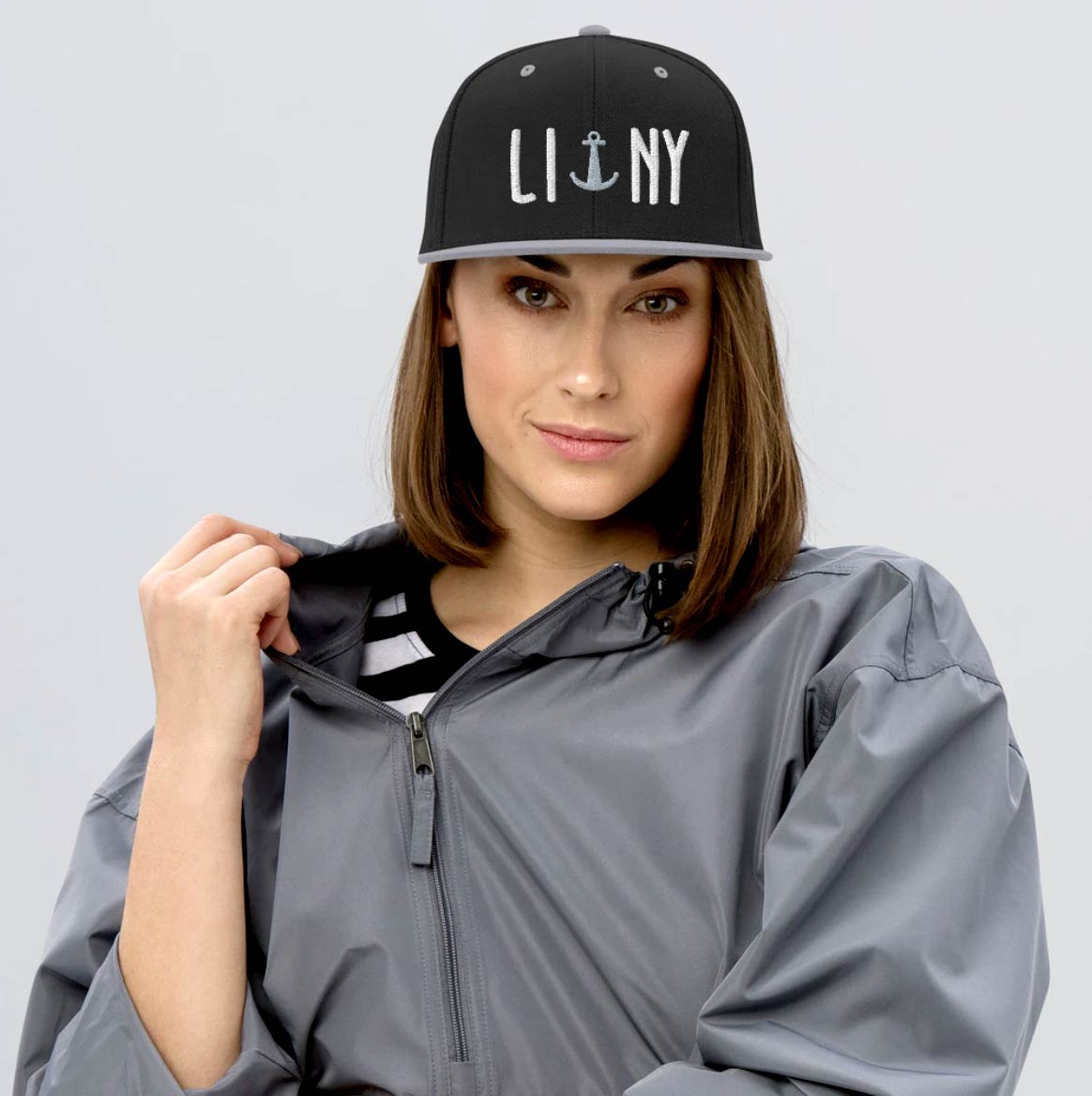 Young beautiful brunette woman wearing black LINY anchor Long Island New York snapback hat cap