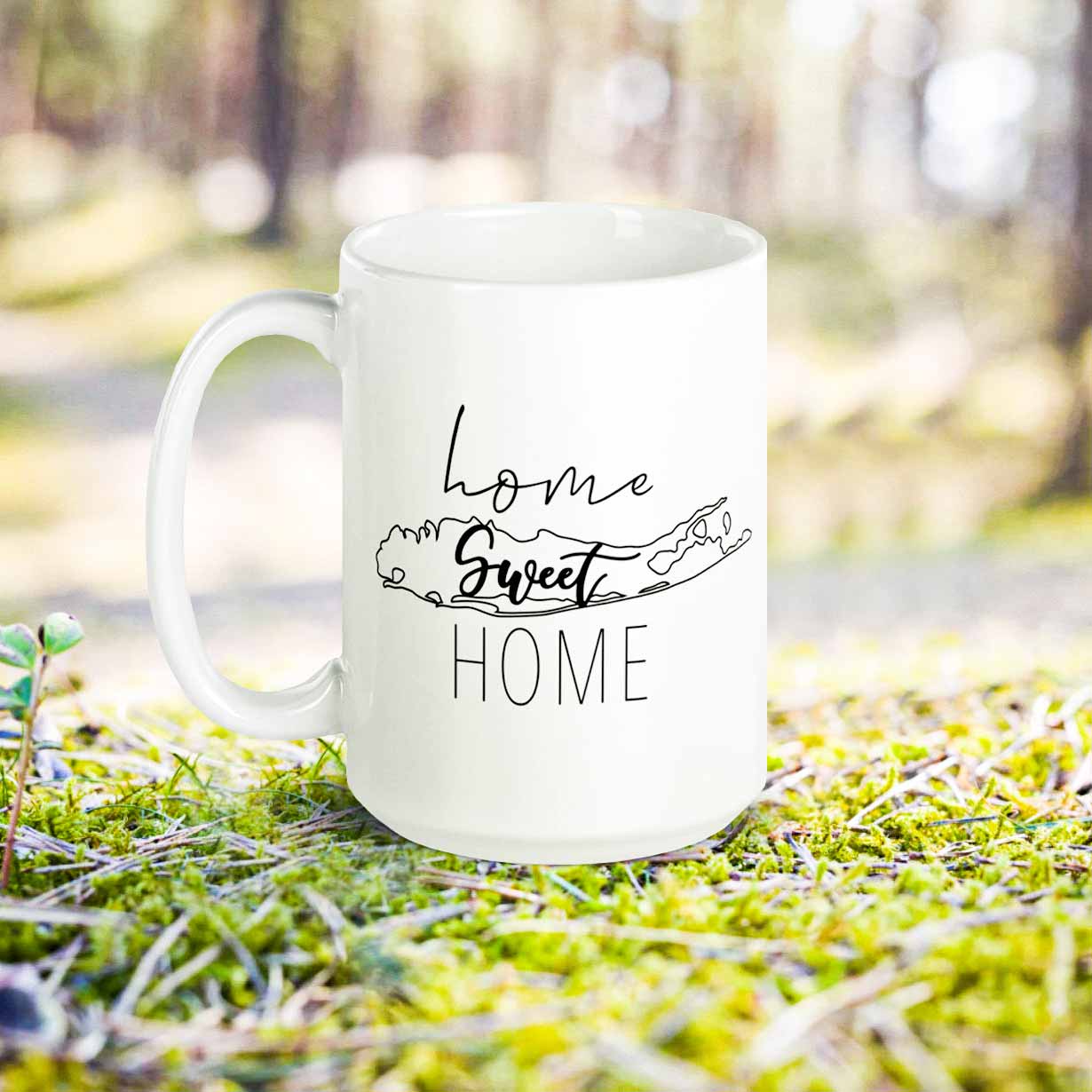 https://atlanticandsound.com/cdn/shop/products/home-sweet-home-long-island-mug-15oz-lifestyle-campsite-forest.jpg?v=1645986304