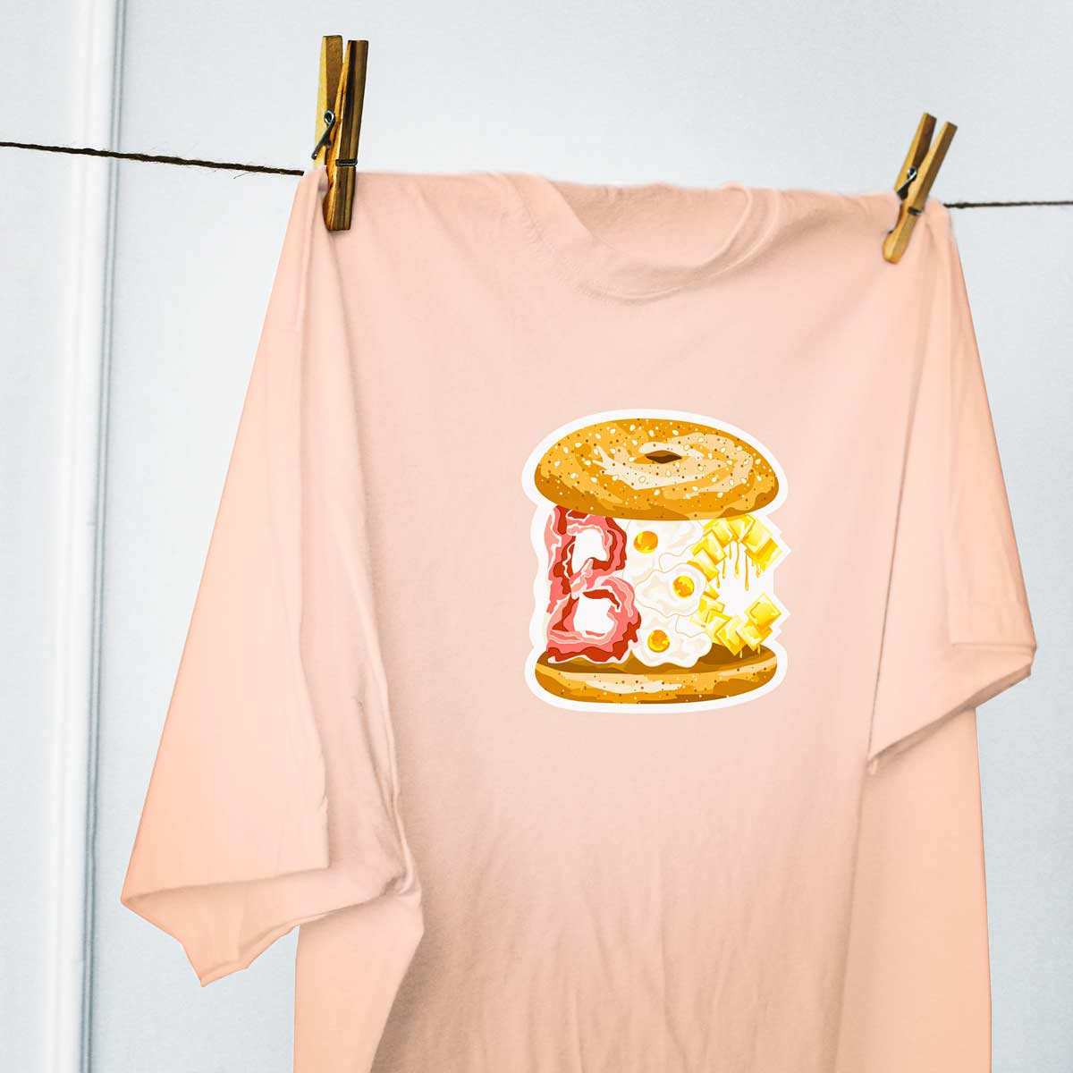 Peach BEC bacon egg and cheese cartoon illustration men's women's unisex t-shirt on clothes line